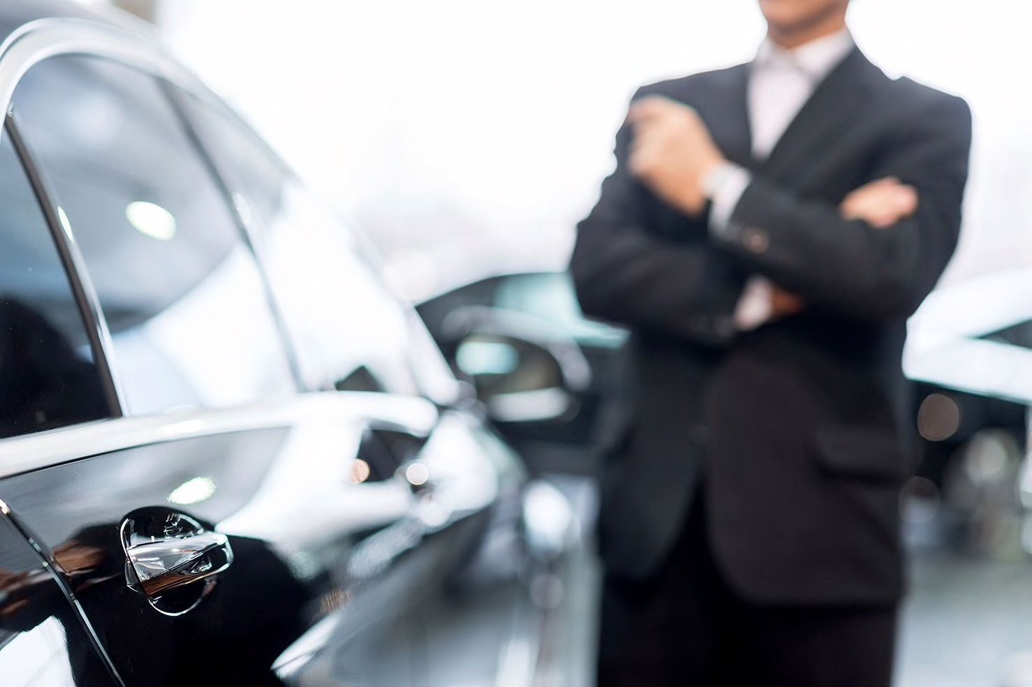 Ford salesman standing next to a car