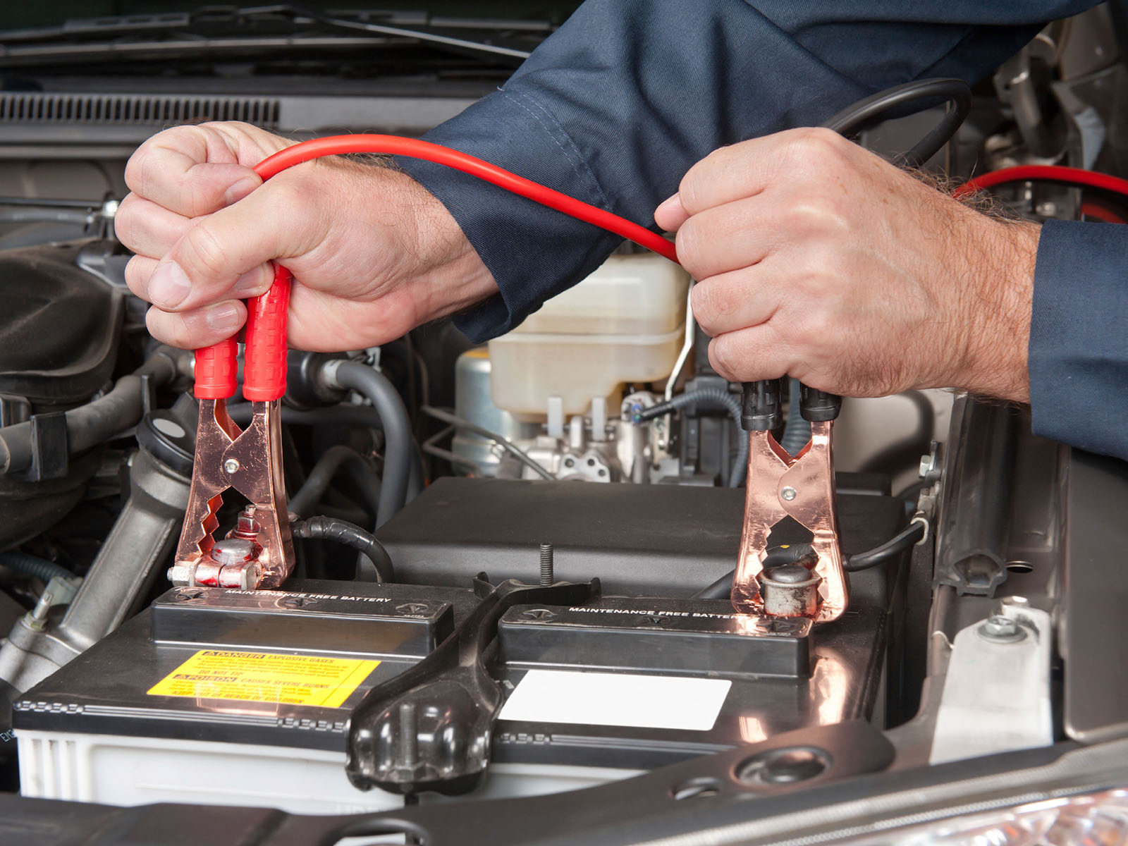 Ford service technician connecting a car battery