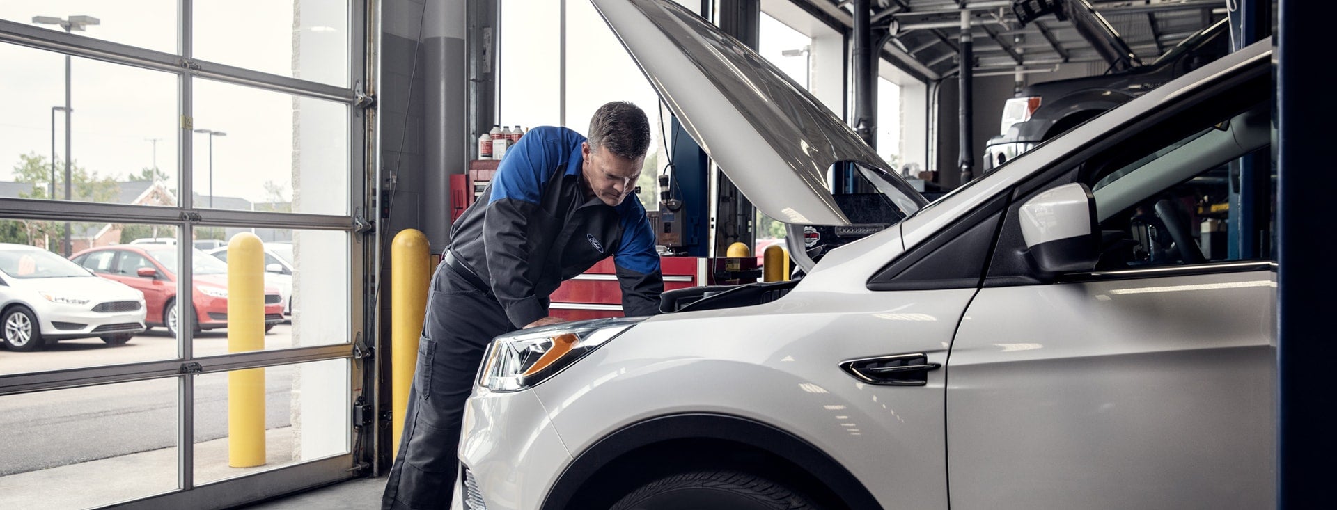 Ford-trained technician performing a 172-point inspection on a certified pre-owned Ford at Sarasota Ford